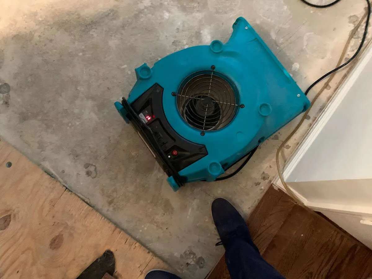 Air mover drying subfloor during Commercial Water Damage Restoration in South Sioux City